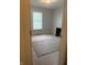 Bedroom with carpeted floors, a window with a view, and a small desk for a simple workspace at 5607 E 500 N, Greenfield, IN 46140