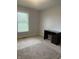 This bedroom features neutral carpeting, a window with blinds, and a built-in desk at 5607 E 500 N, Greenfield, IN 46140