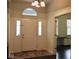 Inviting entryway showcasing a decorative front door and an adjacent room with large windows at 5607 E 500 N, Greenfield, IN 46140