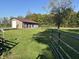 Exterior with expansive lawn, landscaping, and metal fencing at 5607 E 500 N, Greenfield, IN 46140