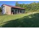 Exterior of building with a metal roof, outdoor seating, and a fire pit at 5607 E 500 N, Greenfield, IN 46140