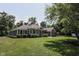 Charming home with a well-manicured lawn, mature trees, and covered front porch, radiating curb appeal at 5607 E 500 N, Greenfield, IN 46140