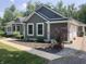 Well-maintained home showcasing an attached garage and landscaped garden with a dog statue at 5607 E 500 N, Greenfield, IN 46140
