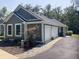 View of the exterior showing the garage and landscaped grounds with a dog statue at 5607 E 500 N, Greenfield, IN 46140