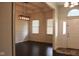 View into the home's entry hall, which shows two bright front windows and dark wood floors at 5607 E 500 N, Greenfield, IN 46140
