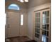 Bright foyer features a white front door with sidelights and glass french doors, providing a welcoming entrance at 5607 E 500 N, Greenfield, IN 46140