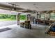 Spacious garage with ample storage, a workbench, and an open door leading to a tree-lined backyard at 5607 E 500 N, Greenfield, IN 46140