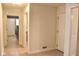 Hallway with neutral walls, tile floors, white trim, and doorway views to adjacent rooms at 5607 E 500 N, Greenfield, IN 46140