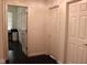 Hallway features multiple closet doors and leads to a separate area with a window view at 5607 E 500 N, Greenfield, IN 46140