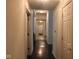 Long hallway with dark hardwood floors leads to the front door and other rooms in the home at 5607 E 500 N, Greenfield, IN 46140