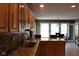 Bright eat-in kitchen with a large island, stainless steel sink, granite countertops, and natural wood cabinetry at 5607 E 500 N, Greenfield, IN 46140