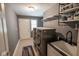 Well-organized laundry room with washer, dryer, sink, storage, and tile floors at 5607 E 500 N, Greenfield, IN 46140