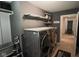 Laundry room featuring gray walls, modern washer and dryer, and floating shelving at 5607 E 500 N, Greenfield, IN 46140