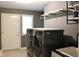This laundry room features a sink, tile floor, and full size washer and dryer at 5607 E 500 N, Greenfield, IN 46140