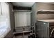 The laundry room includes a modern washer/dryer, storage and utility sink at 5607 E 500 N, Greenfield, IN 46140