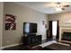 Inviting living room featuring dark wood floors, a fireplace, and a ceiling fan with lighting at 5607 E 500 N, Greenfield, IN 46140