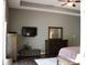 Main bedroom with wooden floors and a ceiling fan, along with wooden furniture including a large dresser at 5607 E 500 N, Greenfield, IN 46140