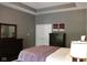 The main bedroom features dark wood furniture, including a dresser, and gray walls with a ceiling fan at 5607 E 500 N, Greenfield, IN 46140