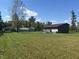 View of the property featuring a well-maintained lawn, sheds, and a house at 5607 E 500 N, Greenfield, IN 46140