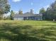 Spacious home exterior featuring an attached three-car garage and generous backyard at 5607 E 500 N, Greenfield, IN 46140