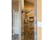 This accessible shower features earth-tone stonework, pebble flooring, a built-in niche, and a detachable shower head at 5607 E 500 N, Greenfield, IN 46140