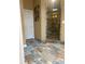 A modern shower showcases earth-tone stonework, pebble flooring, and frameless glass doors at 5607 E 500 N, Greenfield, IN 46140