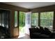 A bright sunroom with a cozy sofa, open door to the backyard, and natural light at 5607 E 500 N, Greenfield, IN 46140