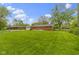 Expansive backyard featuring a well-maintained lawn and mature trees, perfect for outdoor activities at 5846 Linton Ln, Indianapolis, IN 46220
