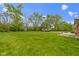 The backyard features a grassy lawn, mature trees, storage shed and a camper at 5846 Linton Ln, Indianapolis, IN 46220