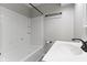 Bright bathroom featuring a white tub shower, sleek fixtures, and minimalist design at 5846 Linton Ln, Indianapolis, IN 46220
