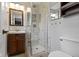 Elegant bathroom with marble-tiled shower, wooden vanity, and stylish fixtures at 5846 Linton Ln, Indianapolis, IN 46220