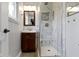 Elegant bathroom featuring a marble-tiled shower, wooden vanity, and sleek fixtures at 5846 Linton Ln, Indianapolis, IN 46220