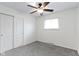 Cozy bedroom with neutral carpet, a ceiling fan, and a closet at 5846 Linton Ln, Indianapolis, IN 46220