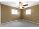 Bedroom with two windows, carpet floors, ceiling fan, and painted walls at 5846 Linton Ln, Indianapolis, IN 46220