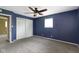 This bedroom features gray carpeting, a ceiling fan, closet and a bright window at 5846 Linton Ln, Indianapolis, IN 46220