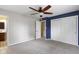 This bedroom features gray carpeting, a ceiling fan, closet and a bright window at 5846 Linton Ln, Indianapolis, IN 46220