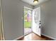 Foyer featuring hardwood floors and a white front door with decorative glass detail at 5846 Linton Ln, Indianapolis, IN 46220
