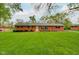 Charming brick home featuring a well-manicured lawn, mature trees, and tasteful landscaping at 5846 Linton Ln, Indianapolis, IN 46220