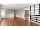 Open living area with hardwood floors, neutral walls, and a view into the dining space at 5846 Linton Ln, Indianapolis, IN 46220