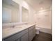Bathroom featuring a double vanity, solid surface countertops and a tub and shower at 6216 Cascades Dr, Whitestown, IN 46075