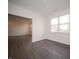 Bright living room adjacent to another room, featuring modern flooring and a large window at 6216 Cascades Dr, Whitestown, IN 46075