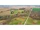 Expansive aerial view of property with fields, trees, pond, barn, and homes at 647 N 100 W, Franklin, IN 46131