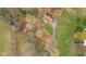 Aerial view of a home surrounded by lush foliage and a stream, showcasing its private setting at 647 N 100 W, Franklin, IN 46131