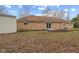 A brick house has a spacious yard with a mulched garden near the building at 647 N 100 W, Franklin, IN 46131