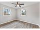 This bedroom has modern flooring, neutral paint, and two well-lit windows with outdoor views at 647 N 100 W, Franklin, IN 46131