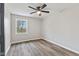 A cozy bedroom features modern flooring, a ceiling fan, and a well-lit window view at 647 N 100 W, Franklin, IN 46131