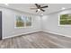 An airy bedroom features light walls, two windows, and warm wood-look flooring at 647 N 100 W, Franklin, IN 46131