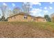 Side view of a brick ranch house with a well-maintained lawn and mature trees at 647 N 100 W, Franklin, IN 46131