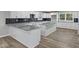 A contemporary kitchen showcasing a spacious island with granite countertops and modern white cabinets at 647 N 100 W, Franklin, IN 46131