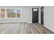 Sunlit living room featuring sleek flooring, a large window, and a stylish black front door at 647 N 100 W, Franklin, IN 46131